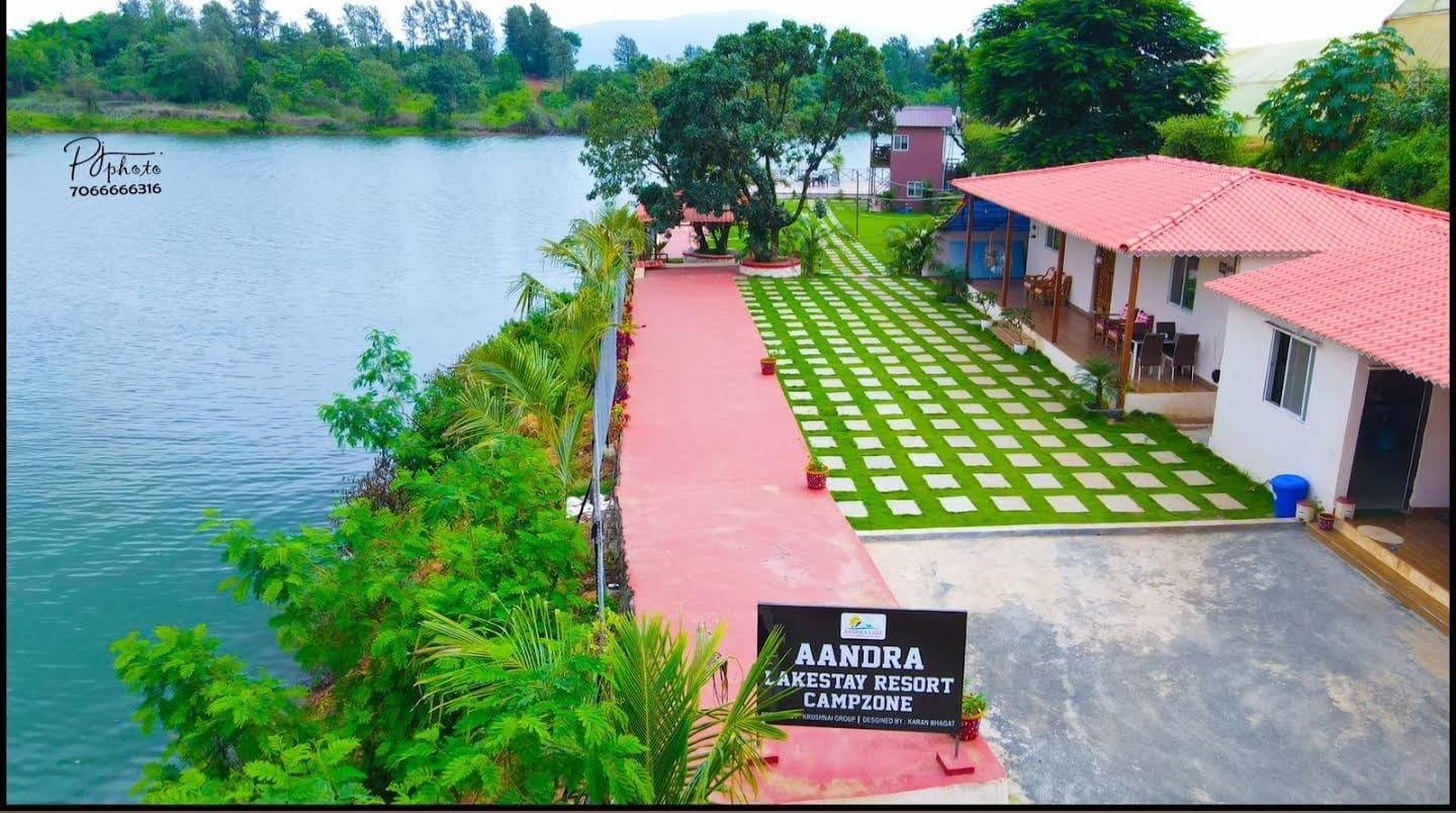 Aerial view of the lakeside walkway, chequered lawn paving and guest pavilion at the entrance to Aandra Lakestay Resort & Campzone