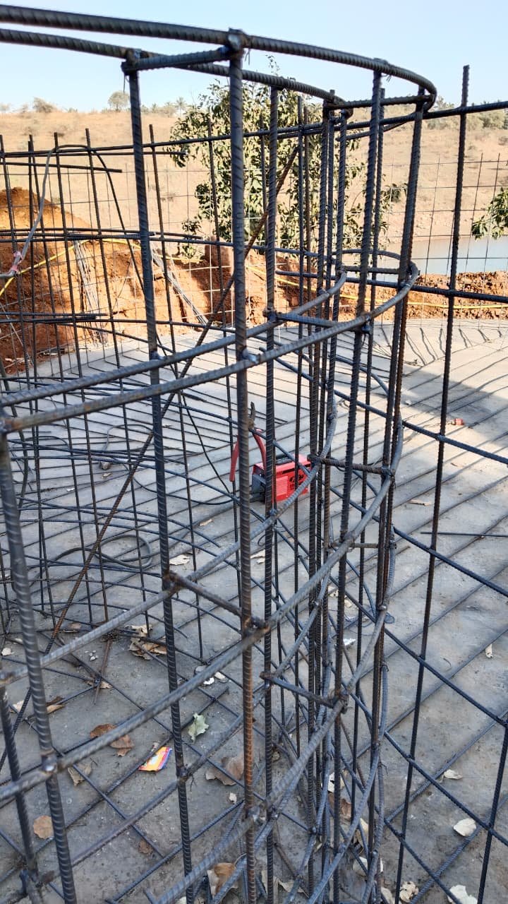 Close view of a tied circular reinforcement cage before concreting at Aandra Lakestay Resort, Pune