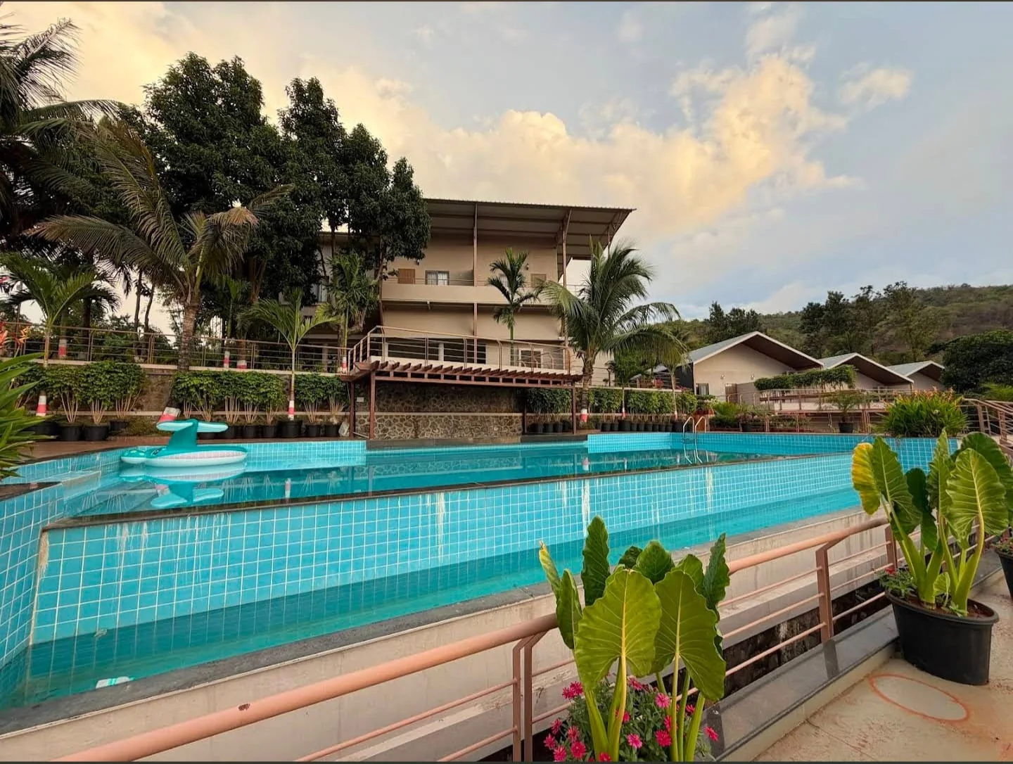 Jalashay Resort by PBJ Infra — pool, guest block and villa cottages lit at dusk